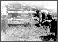 Failing "750" test drill setup on test 3-A-48, northwest of Raymond, Nebraska. Vince Dreeszen, on the right, is washing samples, 1948.