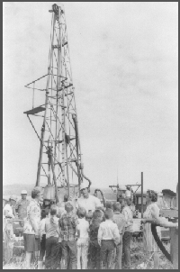 Jim Goeke explaining the techniques of test drilling to school children near Arthur, Nebraska in 1971. The driller is Gene Debus, his assistant is Bob Hansen.