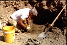 Miner digging sapphire-bearing gravel, Montana.