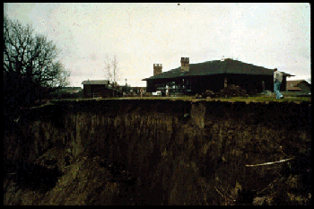Close-up from the previous photograph of the Earth Slump near Fremont, Nebraska. At least three houses were moved due to this threatening landslide. The slide was probably caused by individual septic systems and underground sprinkler systems saturating the bluff overlooking the Platte River.