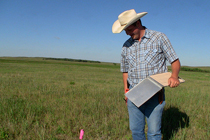 With detailed notes and pictures, Ben catalogs the vegetation at each site. The information will be used to determine the prairie chicken's preferred habitat, a potential resource for private landowners who hope to manage for and attract the native bird to their land.