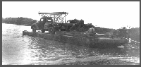 Backing the drill rig onto an island in the Missouri River during the Henningson Consulting investigations, early 1940s.