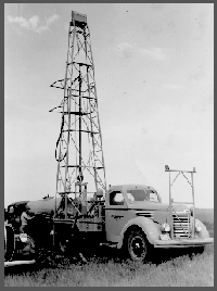 May 21, 1945. Failing Model "750" drill, on test hole 03-A-48, 3 miles north and 3 miles west of Raymond, Nebraska, 22-12N-5E, Lancaster County, Nebraska. V.H. Dreeszen, assistant geologist, at side of truck; James Nelson, driller, at drill controls.