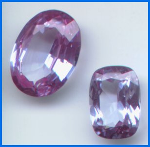 Synthetic spinel aquamarine substitutes. Purplish hue results from selective absorption and transmission of light.