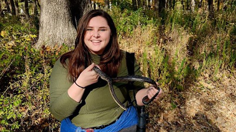 Hannah Miller with black rat snake