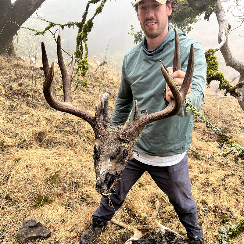 Jake Harvey with Black tailed deer carcus.