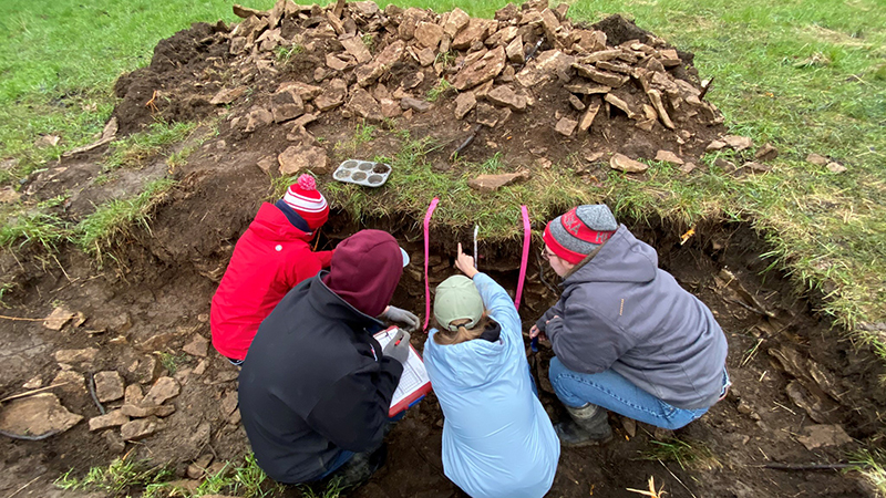 Soil Judging team working on a soil profile” class=