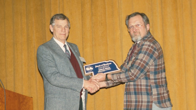 Robert Thomas with award
